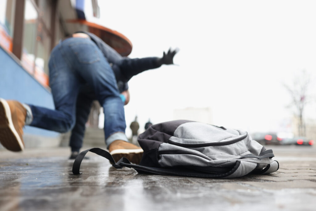 Person Getting Injured After Falling On Slippery Wet Ground